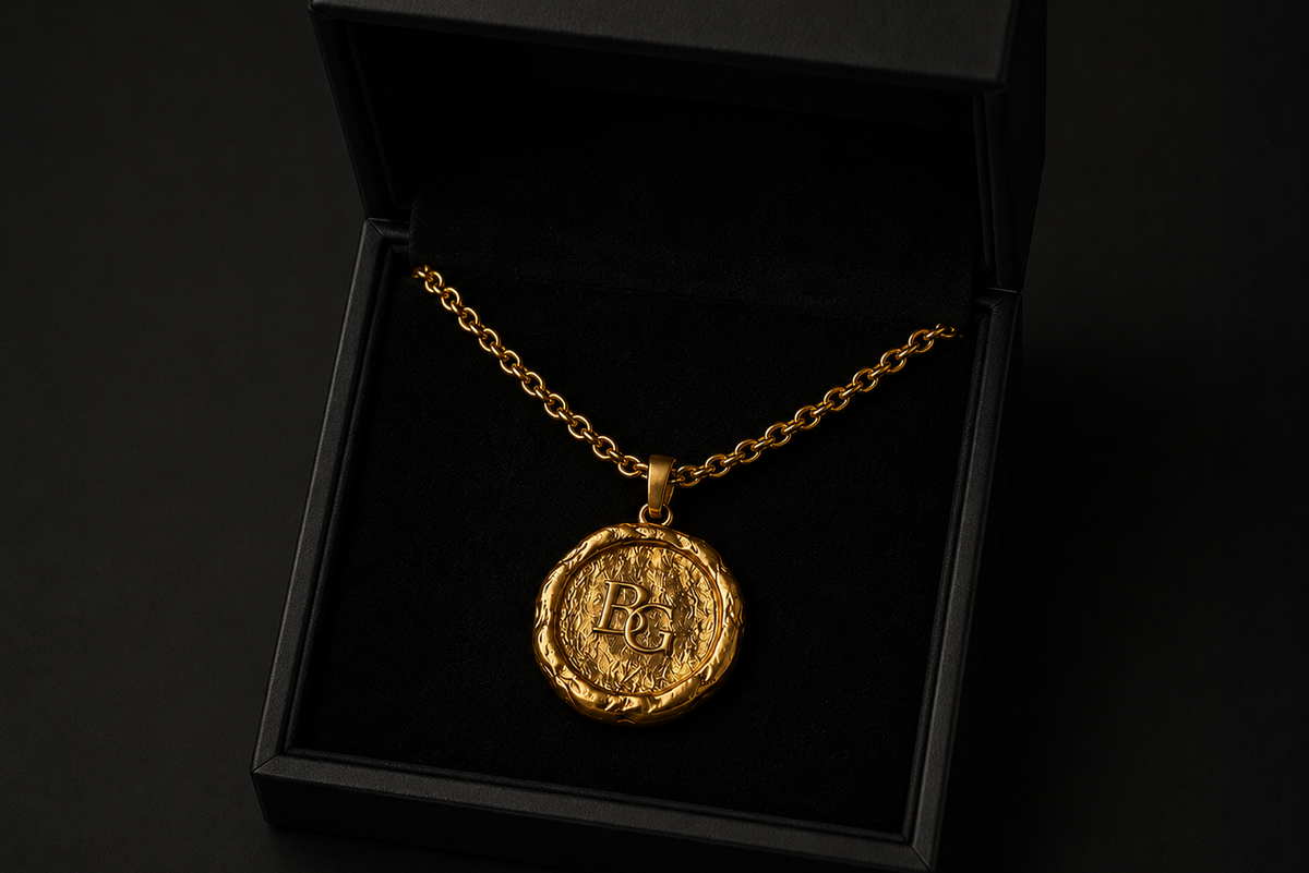 The BG Medallion in 24k gold, presented in its case